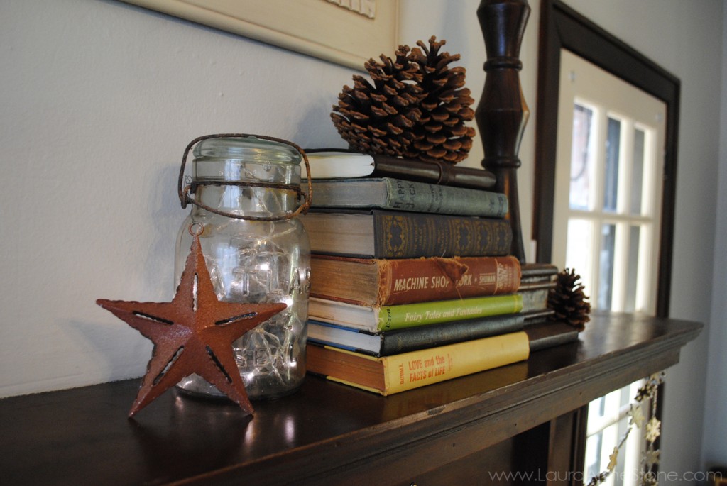 2013 Winter Holiday Mantle - live boxwood wreath vintage books pine cones iron star mason jar twinkle lights - LauraAnneStone.com